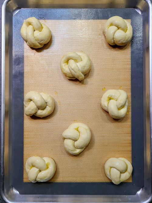 Brushing the Garlic knots with oil