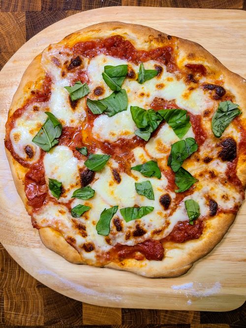 Pizza Margherita topped with shredded basil