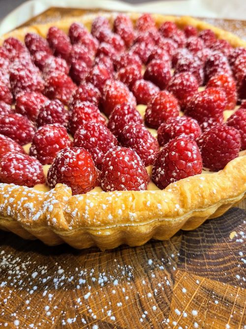 Raspberry tart dusted with sugar