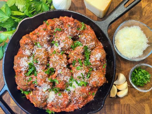 Baked Italian meatballs topped with parmesan and parsley
