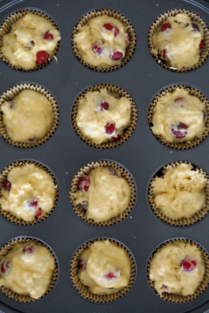 unbaked cranberry orange muffins in a muffin pan