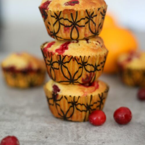 close up of a stack of cranberry orange muffins
