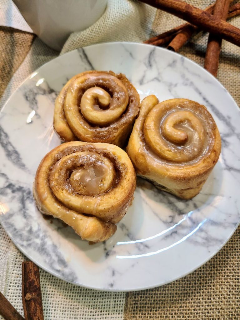 White marble plate with 3 cinnamon maple rolls