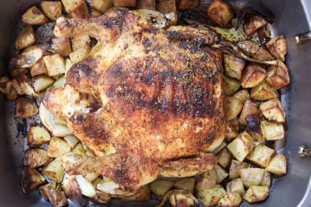 Roasting pan with blackened chicken and roasted potatoes