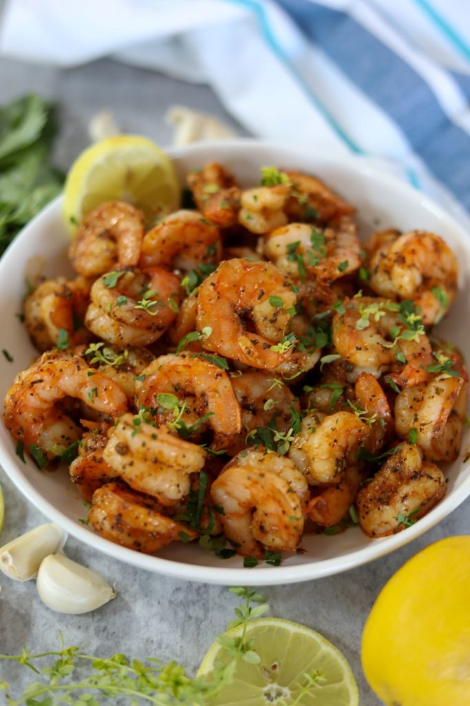 blackened shrimp with garlic in a white bowl