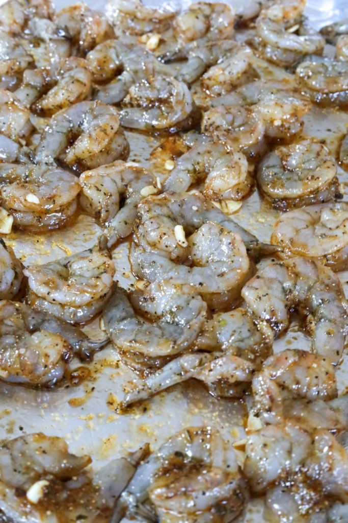 A foiled lined sheet pan with uncooked shrimp