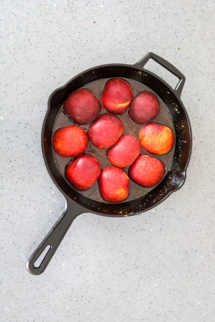 uncooked peaches in a cast iron skillet