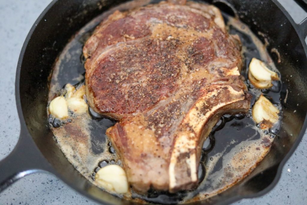 cooked seared steak in a cast iron skillet
