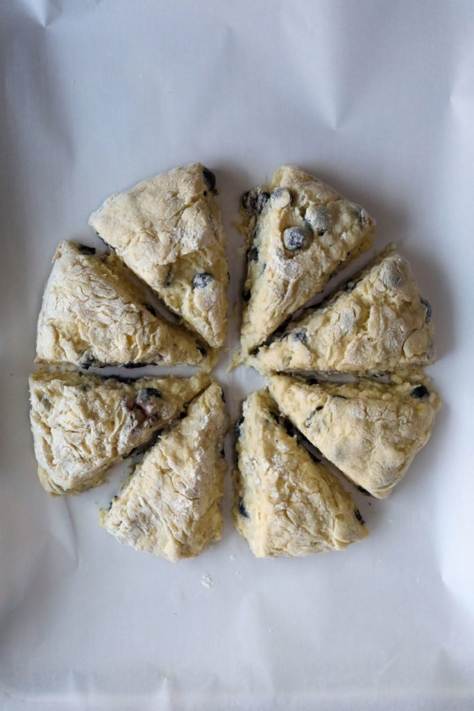 separated sliced scones on a parchment lined sheet pan