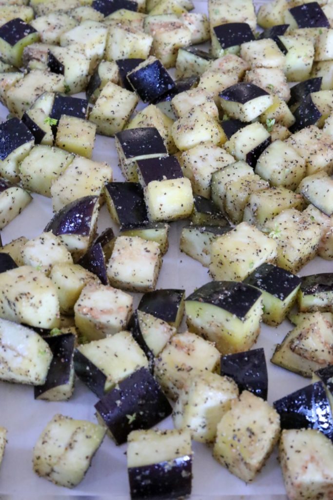 Eggplant cubes on a lined sheet pan