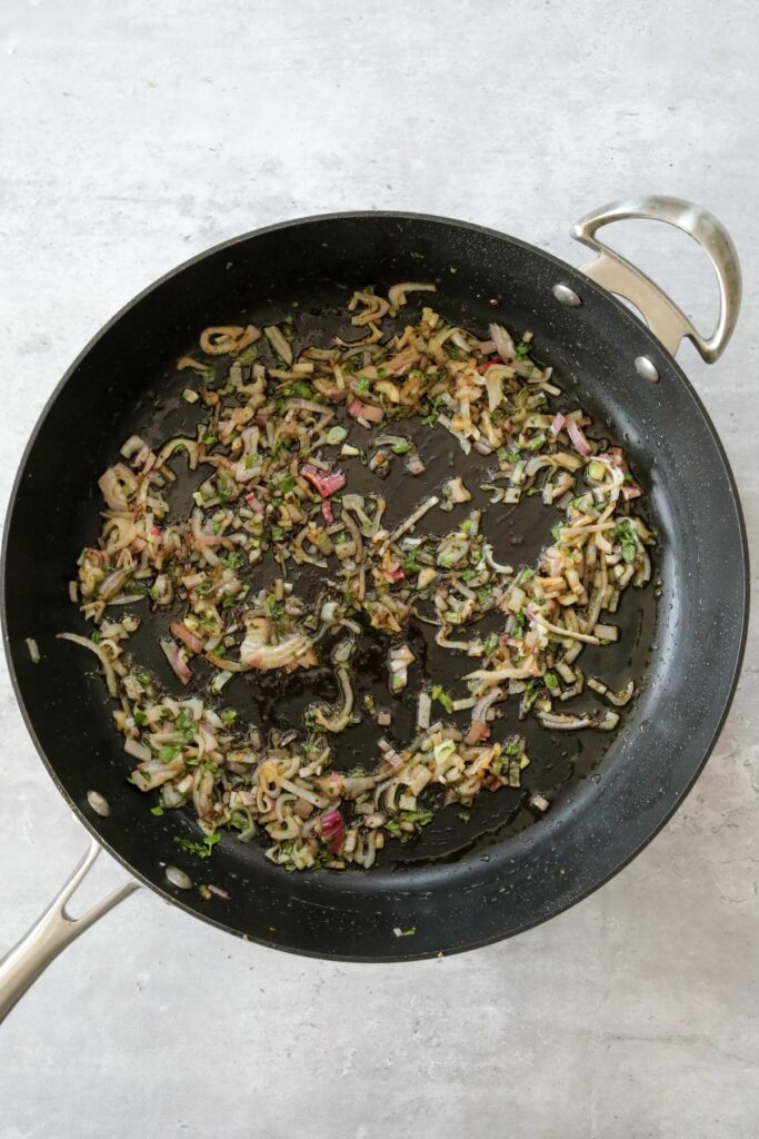Cooked shallots and oregano in a pan