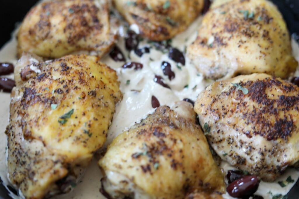 Close up of Greek chicken in a pan with sauce