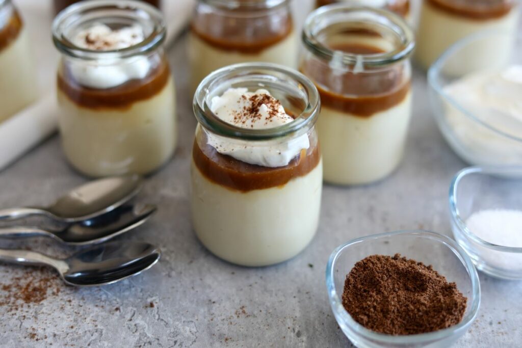 Several jars of bourbon budino with salted caramel sauce.