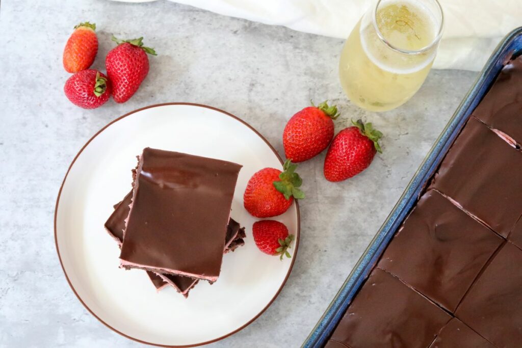 Stack of strawberry brownies with a glass of champagne