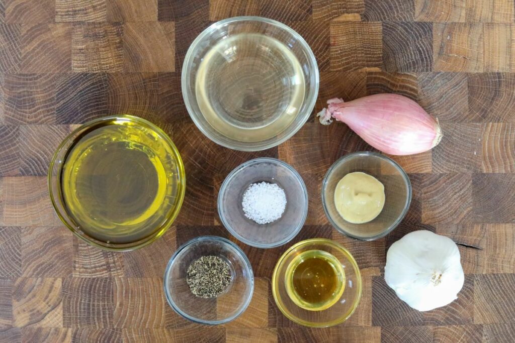 Ingredients for champagne vinaigrette on a cutting board