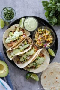 Chicken tacos on a black plate