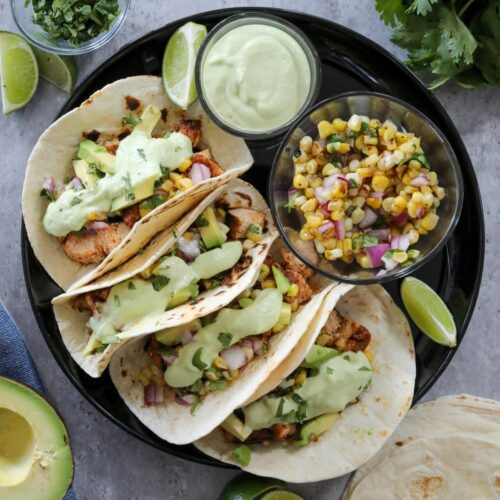 Chicken tacos on a black plate