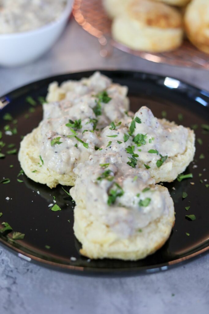 biscuits and gravy on a black plate
