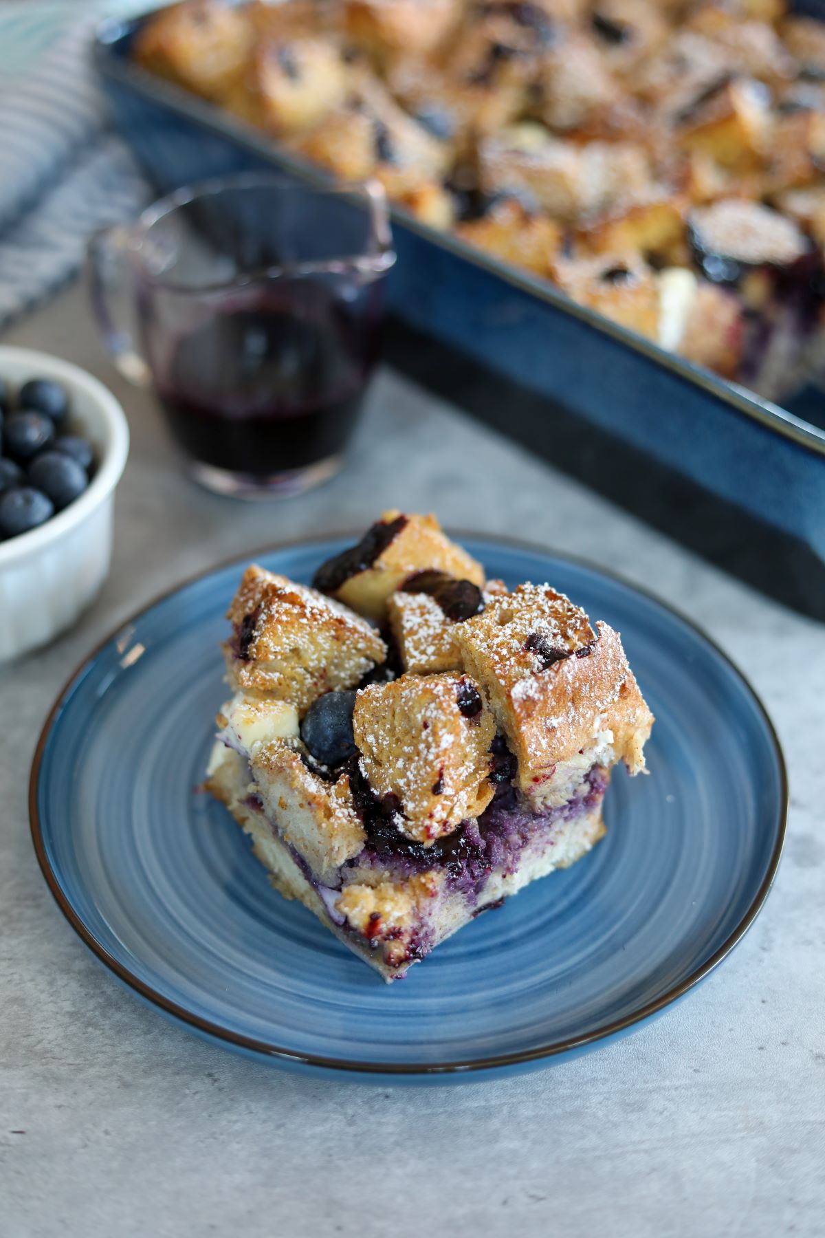 A blue plate with a slice of blueberry French toast
