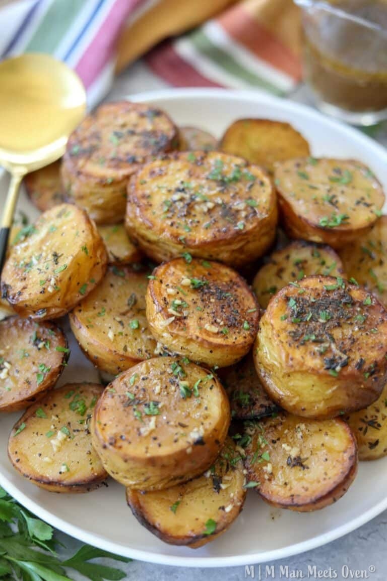 Melting potatoes on a white plate with a spoon
