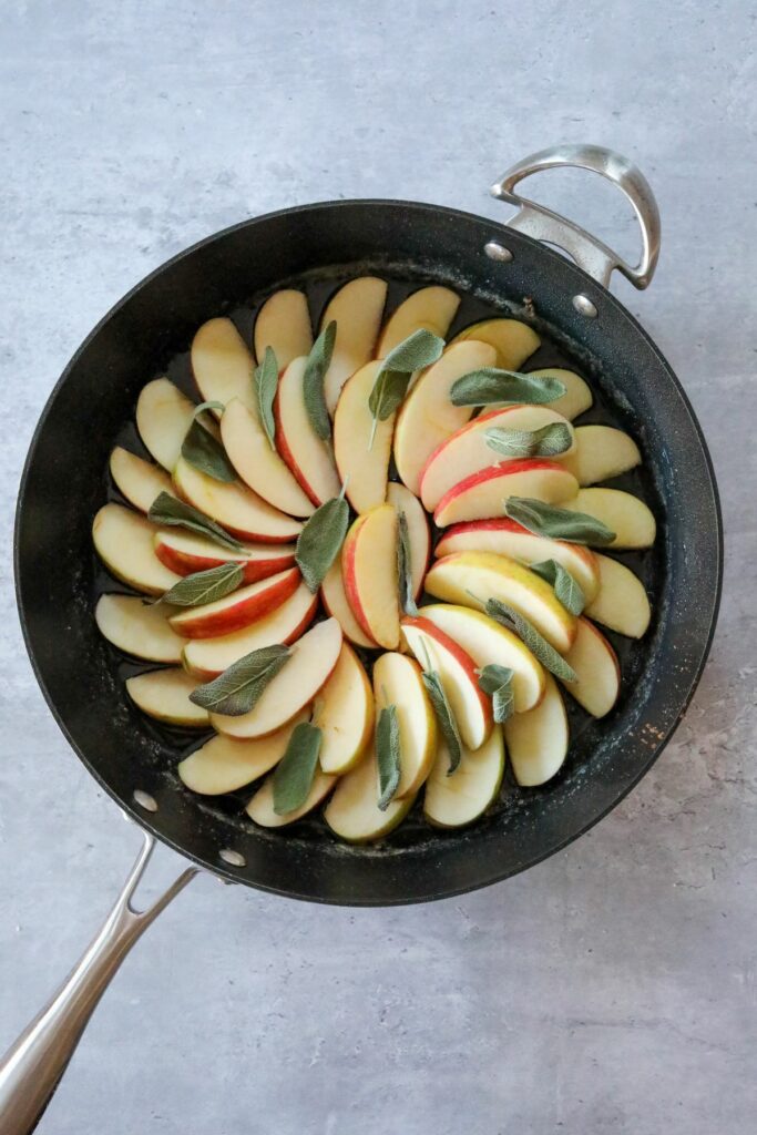 Rings of apple slices and sage in a pan