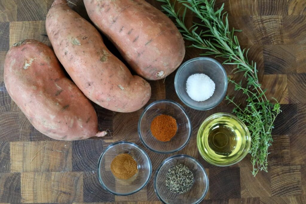 Ingredients for spicy roasted sweet potatoes on a cutting board