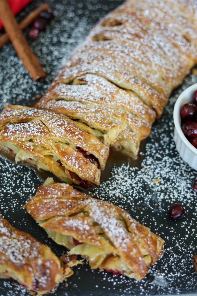 Sliced cranberry and apple strudel on a slate plate