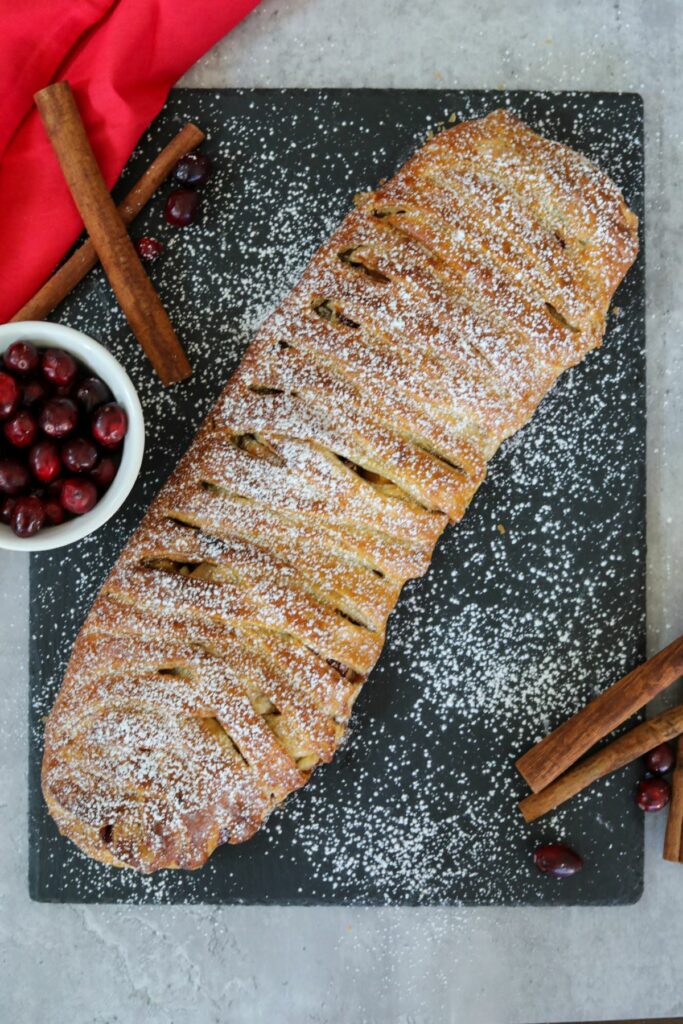cranberry and apple strudel on a slape board