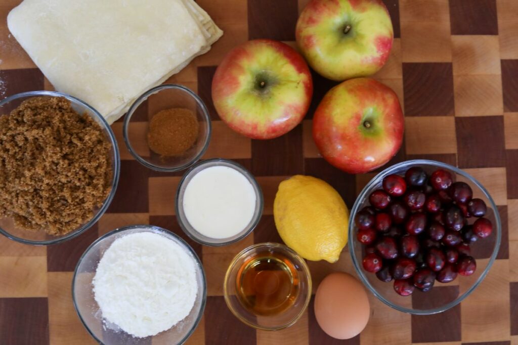 Ingredients for cranberry and apple strudel on a wooden cutting board