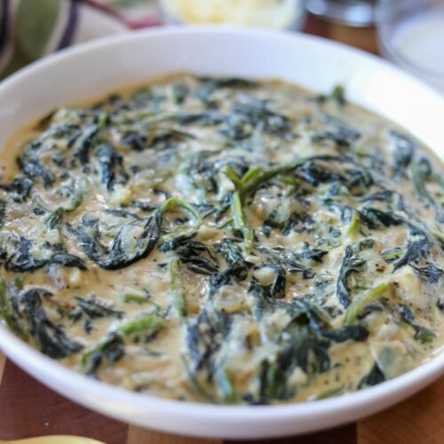 Close up of a white bowl of creamed spinach