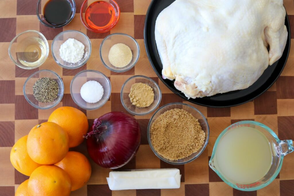 Ingredients for orange glazed chicken on a cutting board