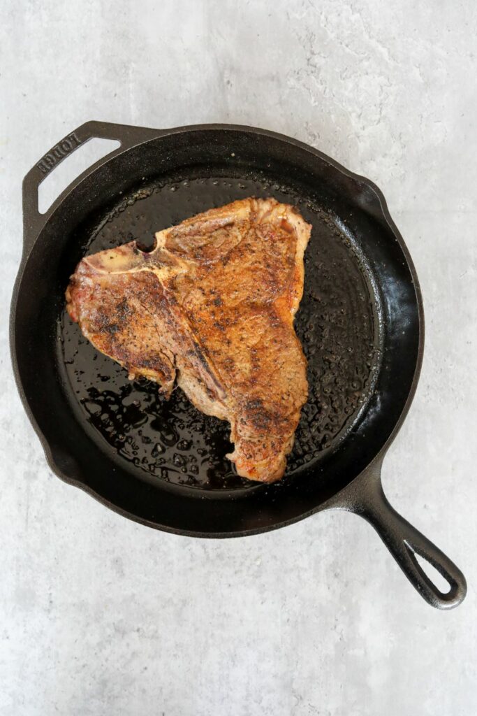 Cooked steak in a cast iron skilet