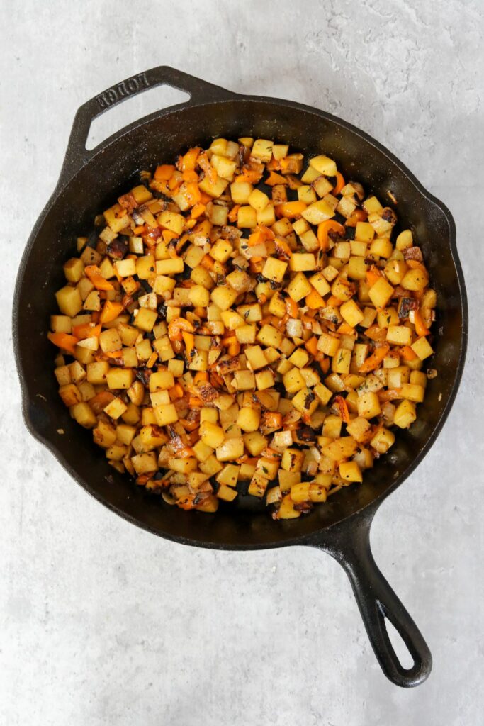 Cooked hash vegetables in cast iron skillet