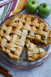 Slice of apple pie in pie dish