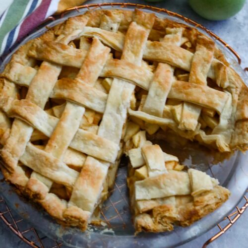 Slice of apple pie in pie dish