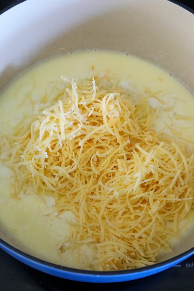 shredded cheese and cream sauce in a pot