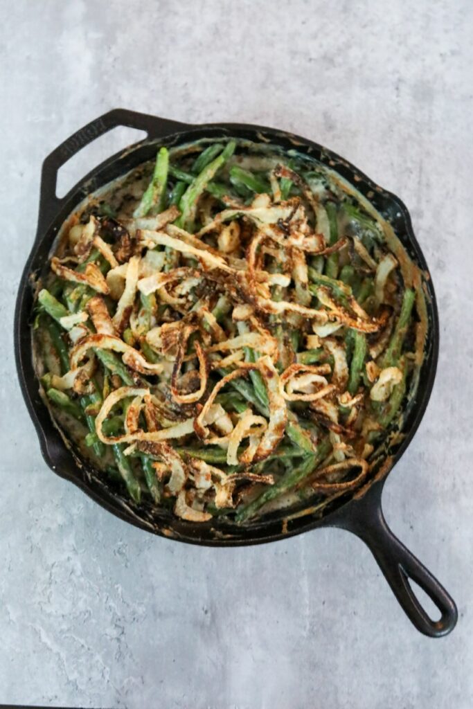 cooked green bean casserole in a cast iron skillet
