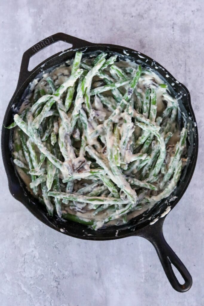 Uncooked green bean casserole in a cast iron skillet