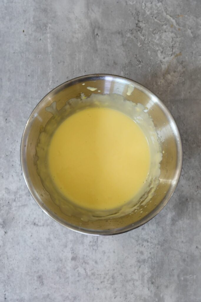 finished hollandaise sauce in metal bowl