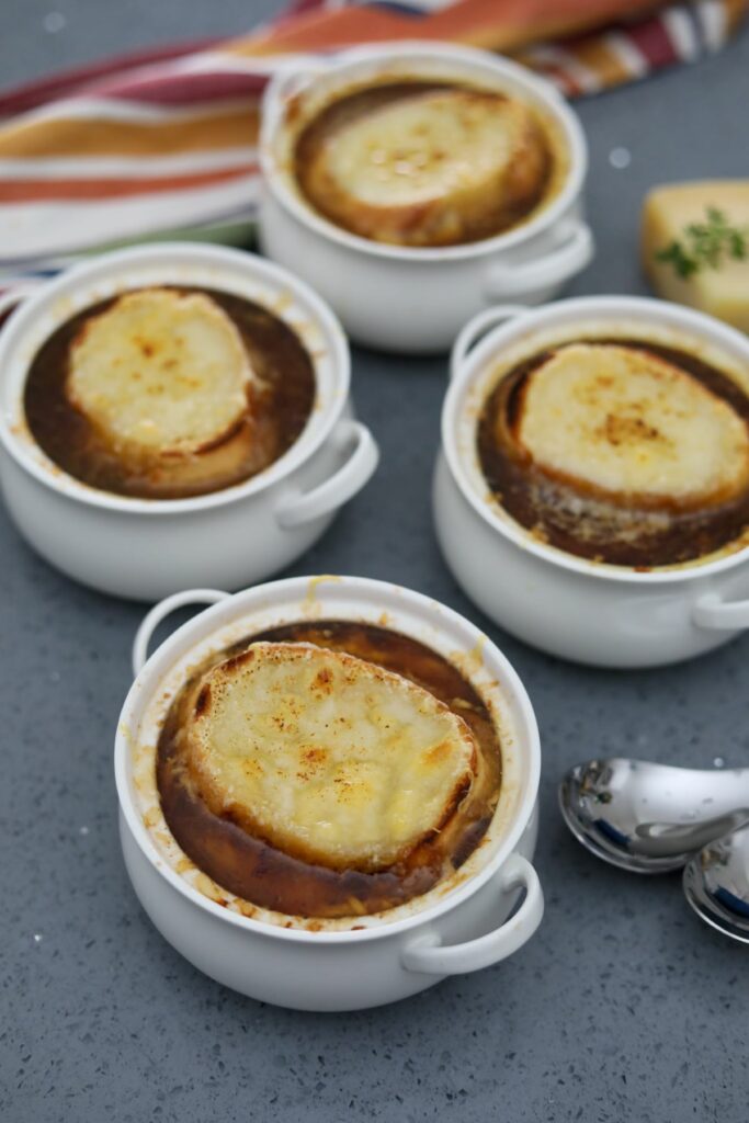 Four bowls of French onion soup.