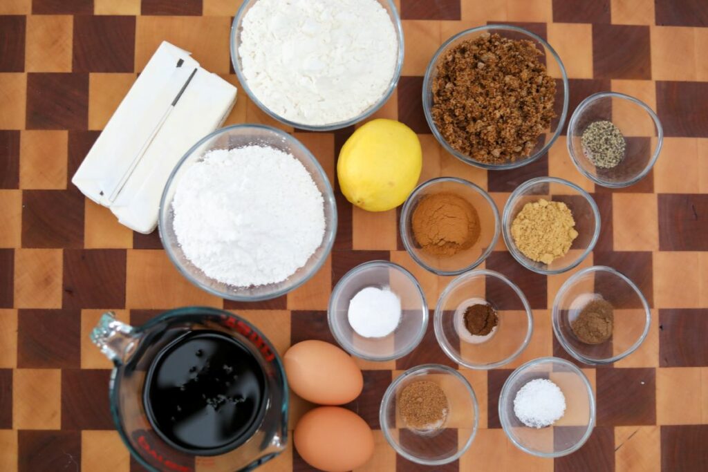 Ingredients for gingerbread cookies on a wooden cutting board