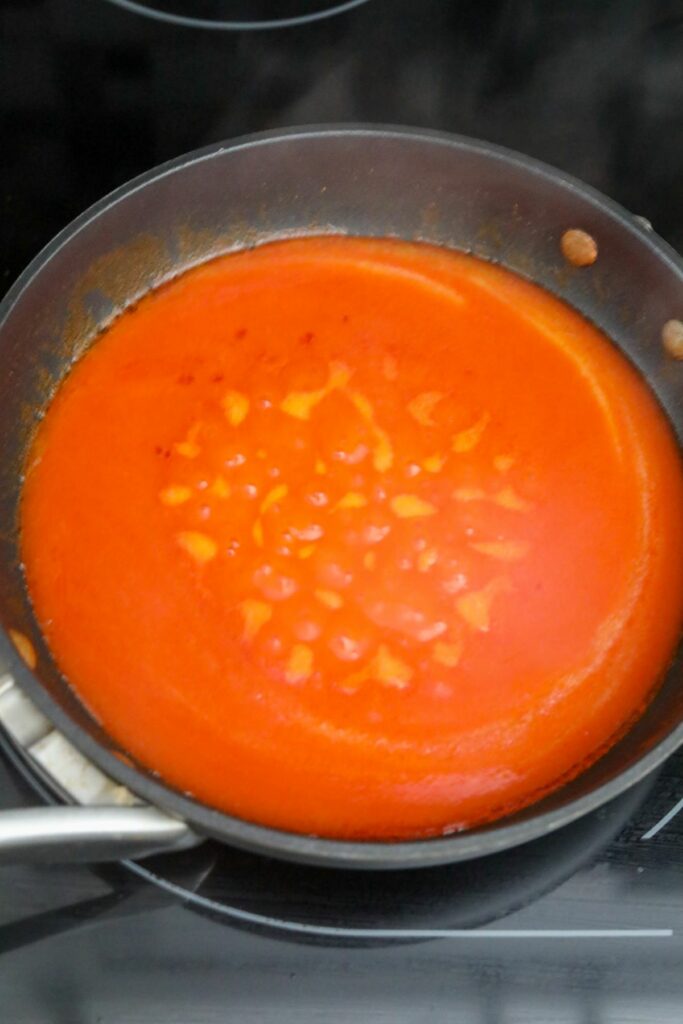 Boiling buffalo sauce in a pan