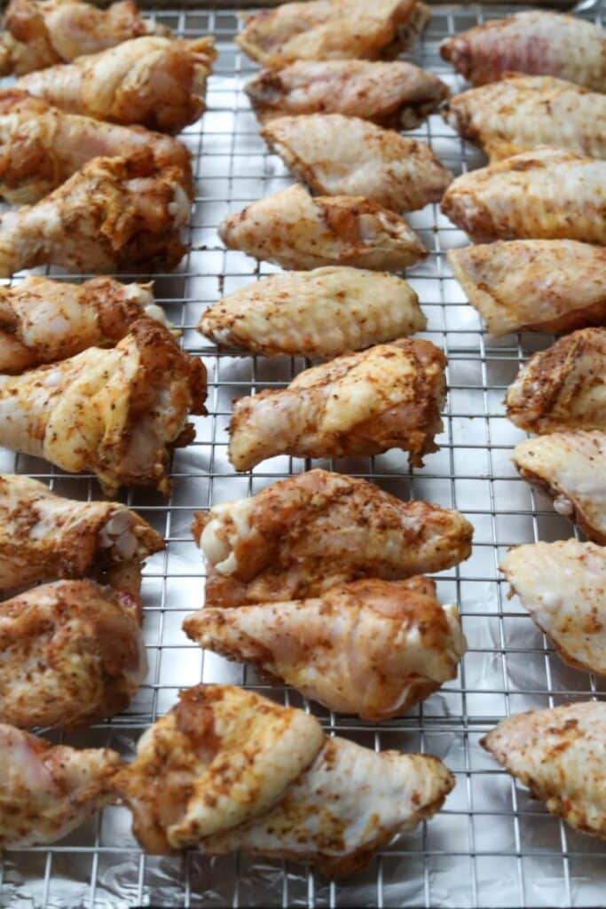 Uncooked wings on a baking rack