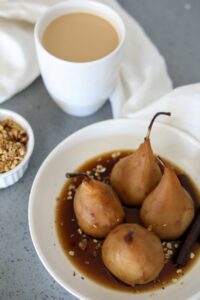 bourbon poached pears in a white bowl