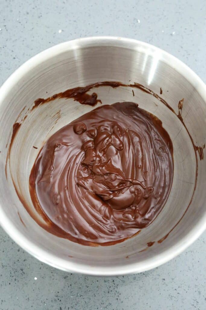 Melted chocolate and butter in a metal mixing bowl