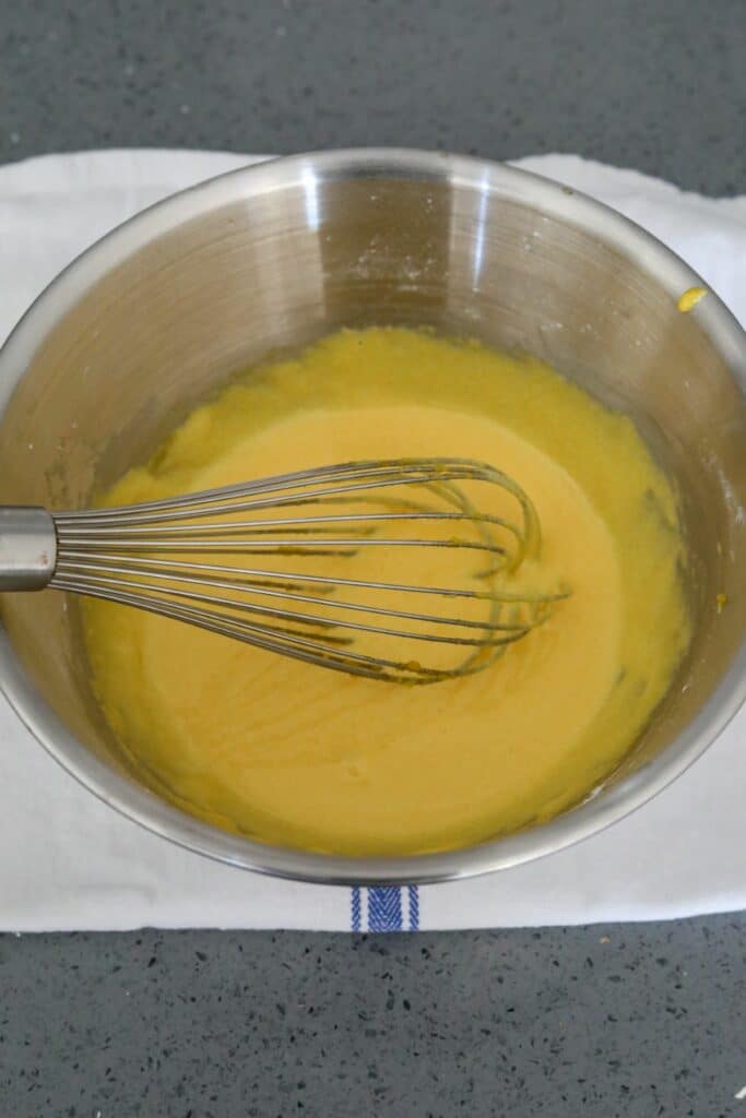 Whisked egg yolk mixture in a mixing bowl