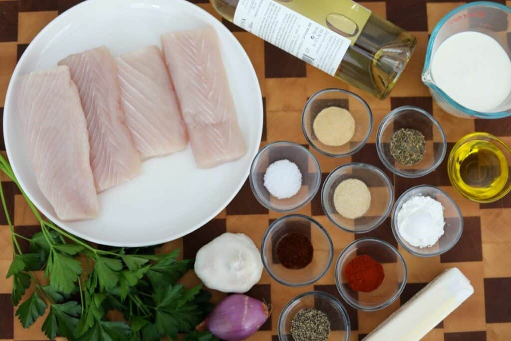 Ingredients for mahi mahi on a wooden cutting board