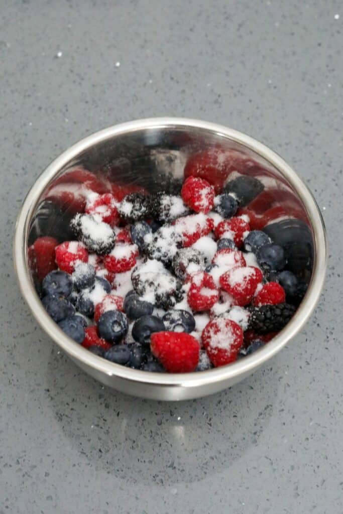 Mixing bowl with berries and sugar