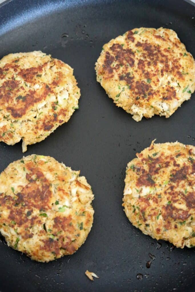 Cooked crab cakes in a skillet