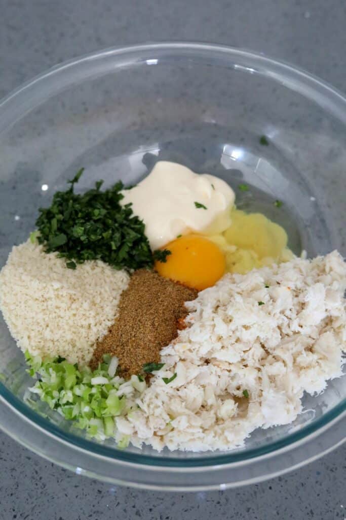 Crab cake ingredients in a glass bowl
